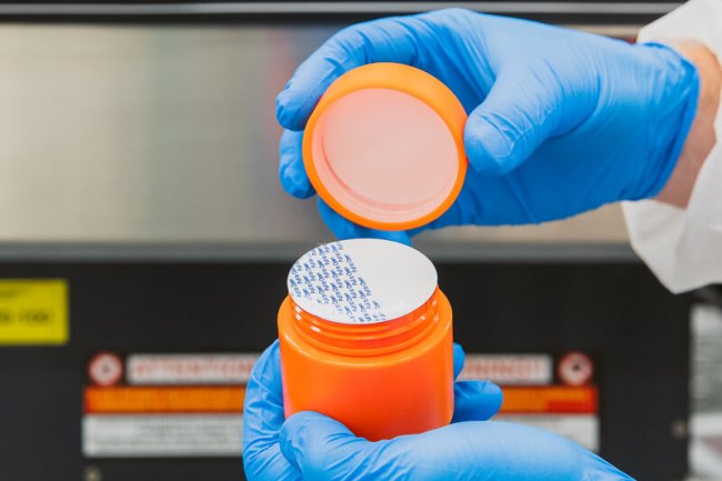 Container filled with induction sealed cap