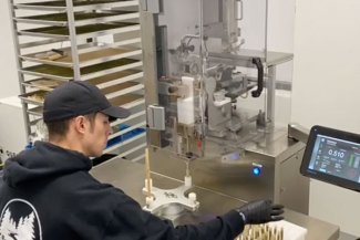JuanaOne machine being used to roll pre roll joint